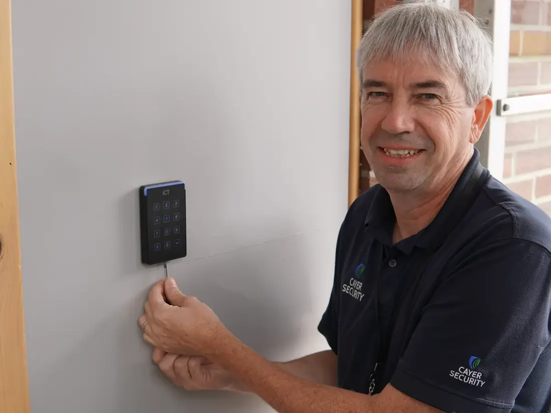 Cayer technician installing an access control keypad